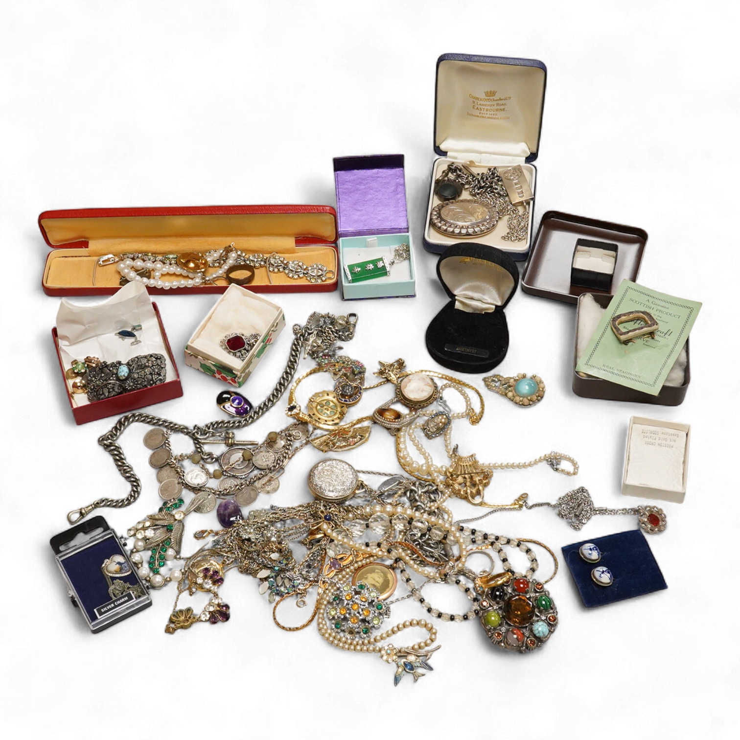 A collection of silver and costume jewellery, including a silver locket, St Christopher ingot pendant and watch chain, and a selection of costume jewels